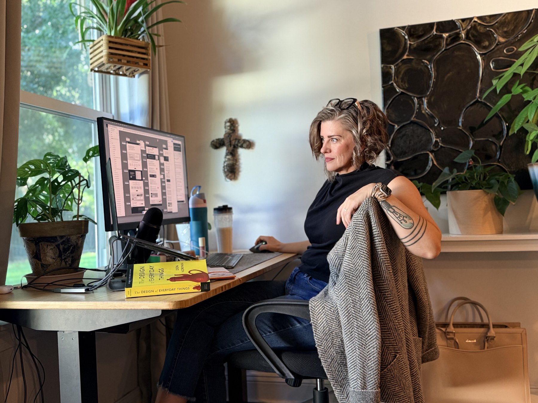 Alicja at her desk reviewing a product design file